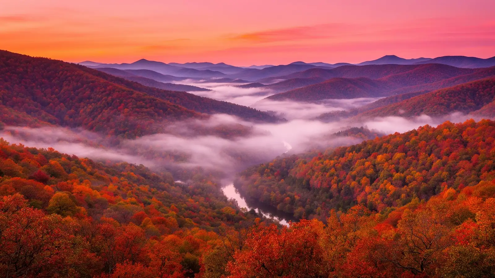 Sunrise over the North Georgia mountains with a river of fog winding through autumn forest